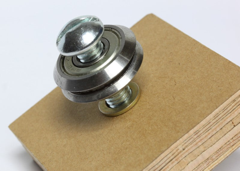 3/8 inch shim washer shown between bearing and a piece of wood.