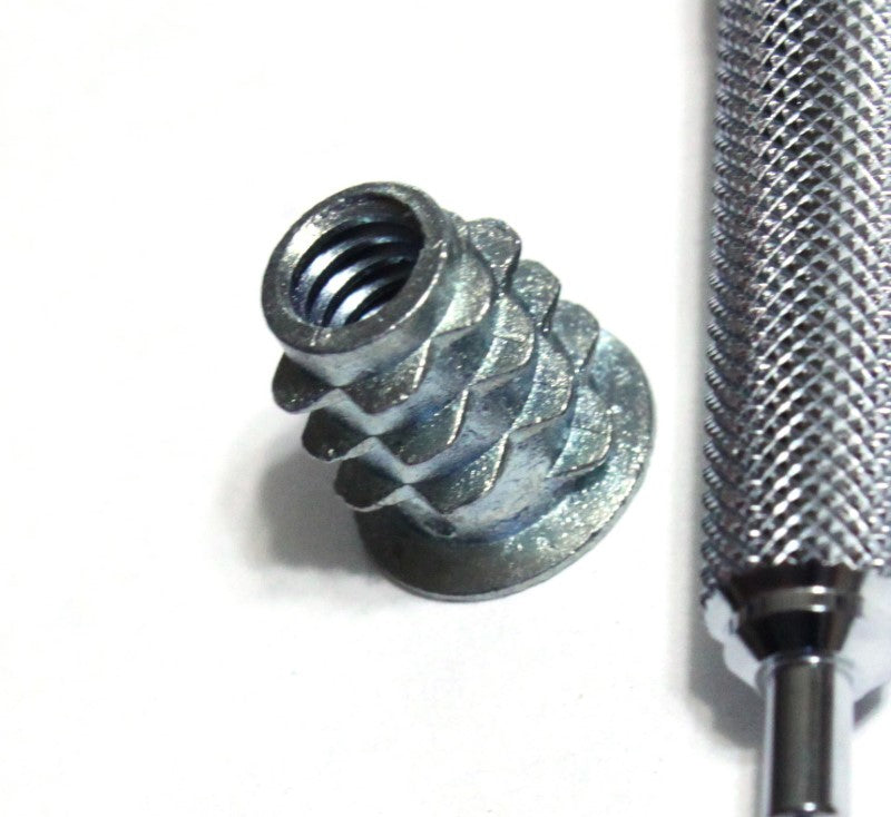 one quarter inch wood insert nut shown next to mechanical pencil for scale