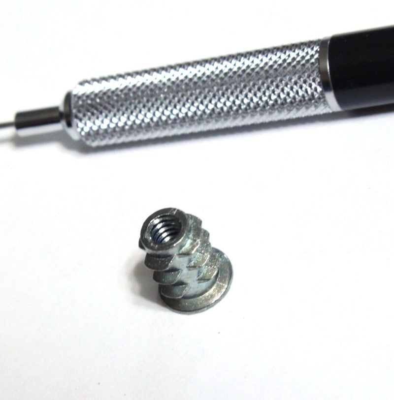 Number Eight insert nut shown with mechanical pencil for scale