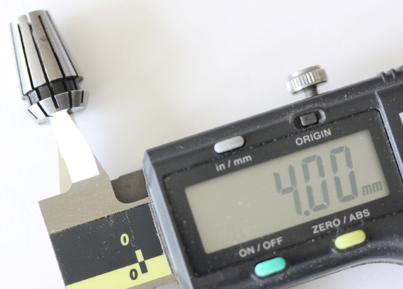 ER11 4mm collet shown with a caliper. The measurement reads 4mm (.15748 mm).
